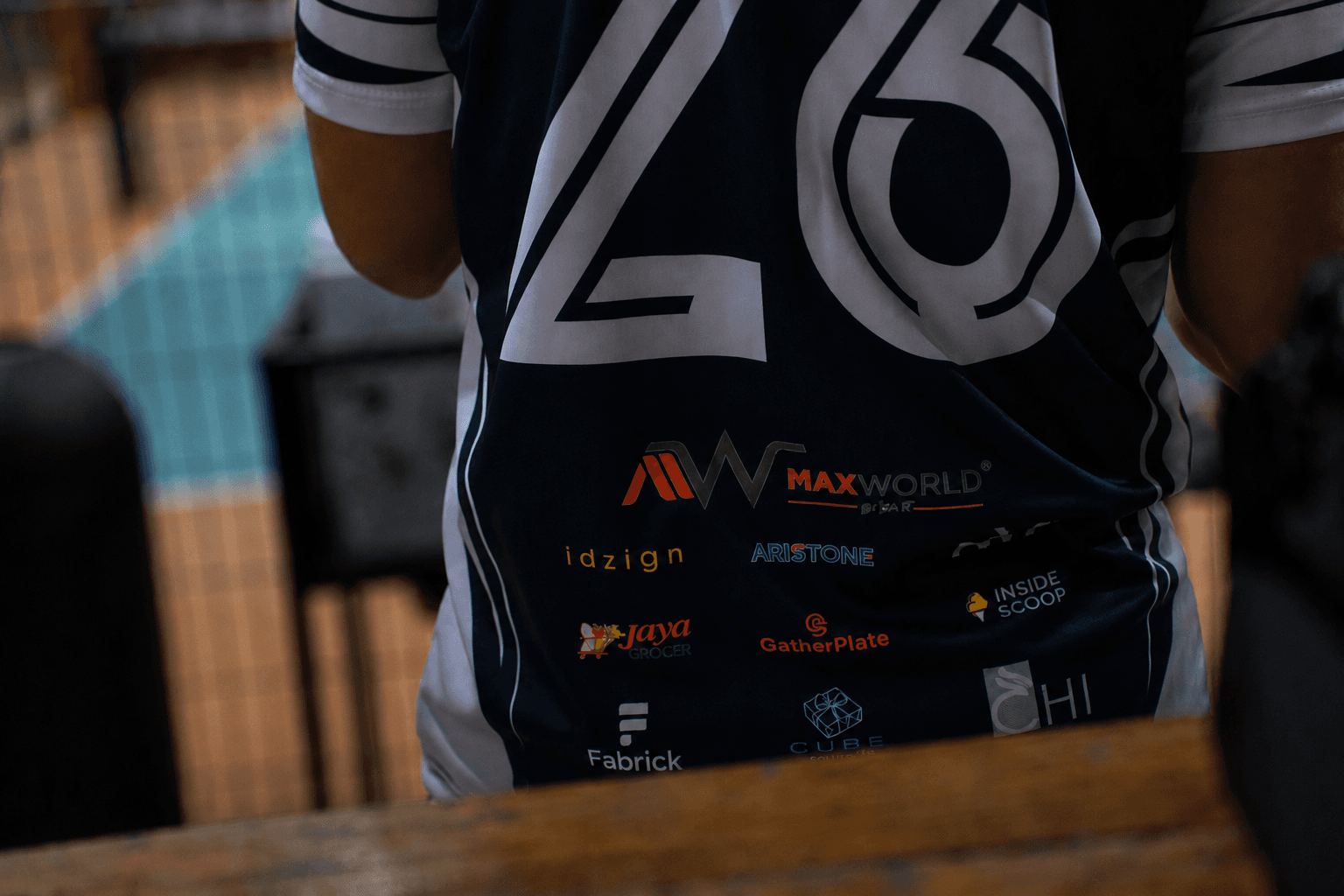 Back of the Pickle 996 Club tournament jersey, number 26, showing community sponsor logos including Maxworld, Jaya Grocer, Aristone, idzign, GatherPlate, Inside Scoop and Fabrick.