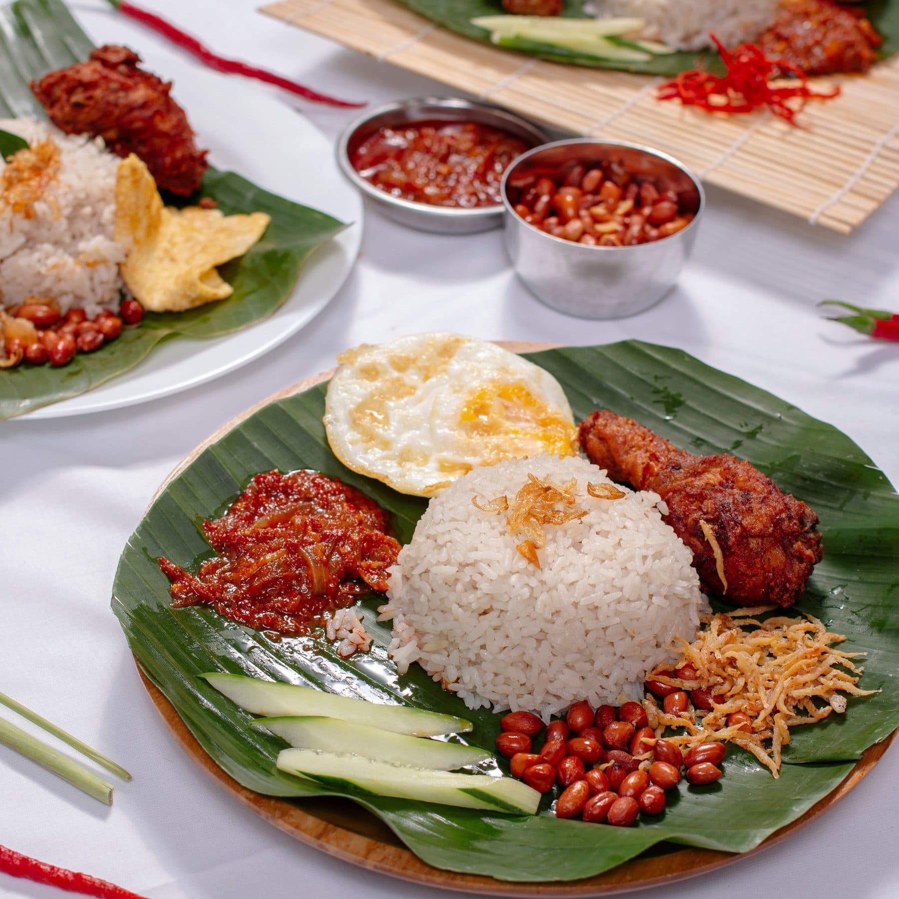 Nasi lemak with fried chicken and sambal on a banana leaf