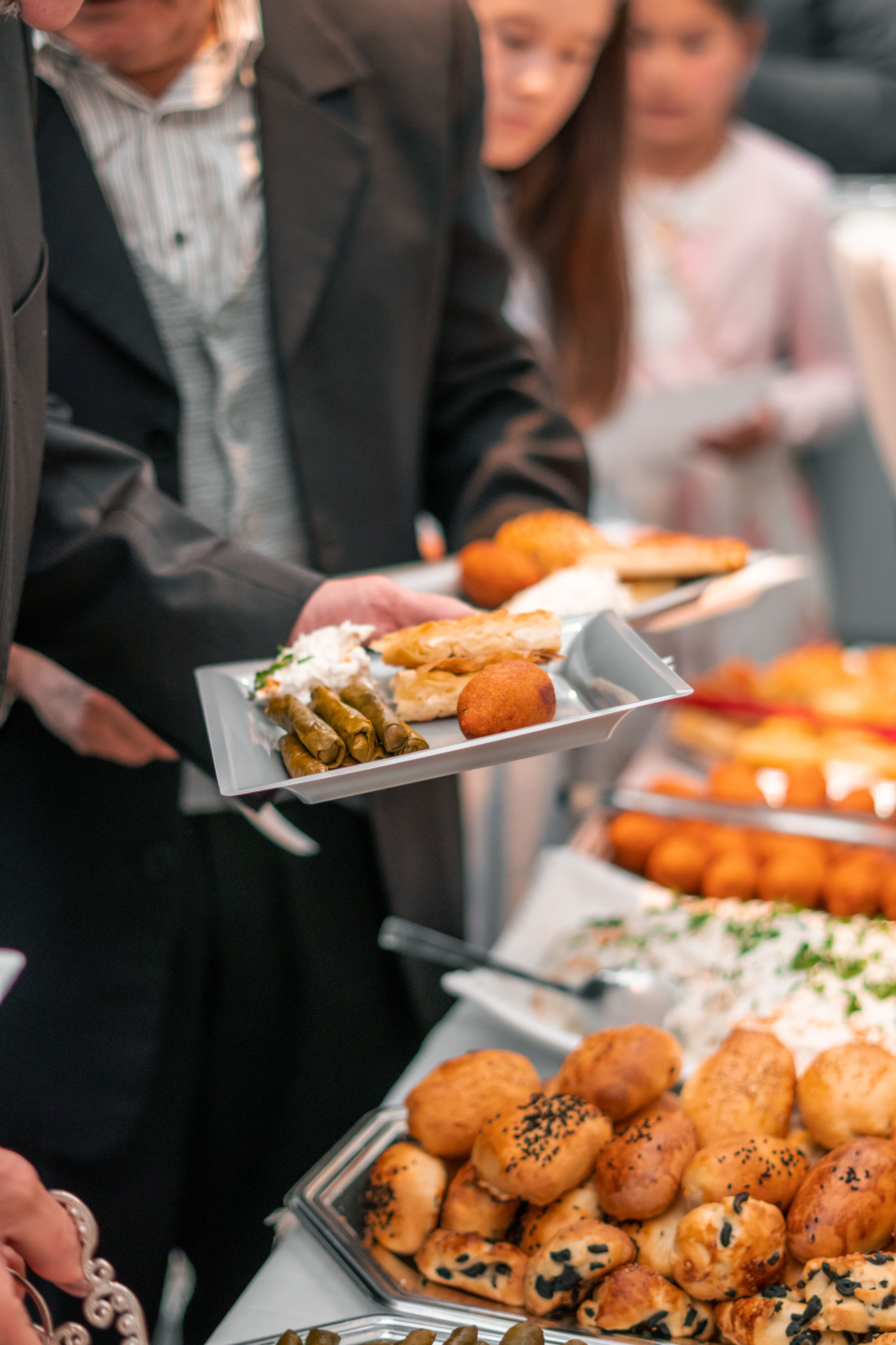 Colleagues with drinks and food at an office gathering