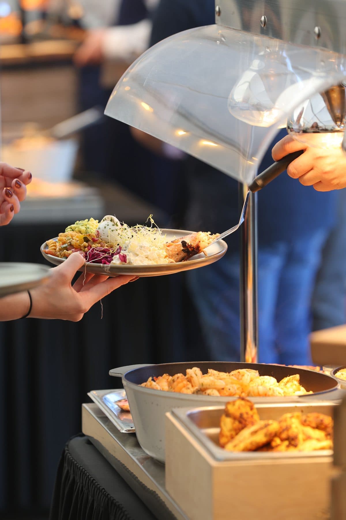 A plate being filled at a catered buffet